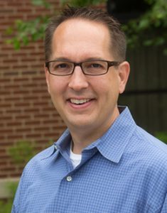 Mark Okonowicz, Project Management Certificate program graduate standing for a head shot outdoors.