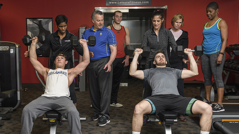 Students weight lifting in Personal Fitness Trainer Course