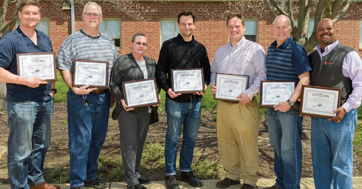 Safety training graduates display their COSS certificates