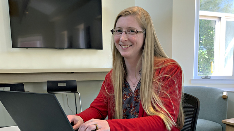 Business Analysis student Jessica Foote looking up from laptop