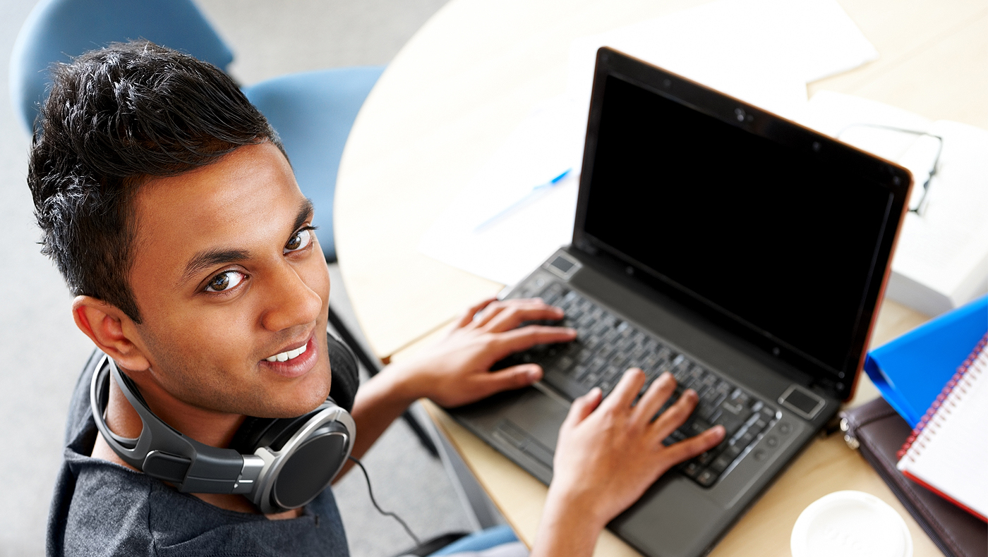 Student looking up from their laptop.