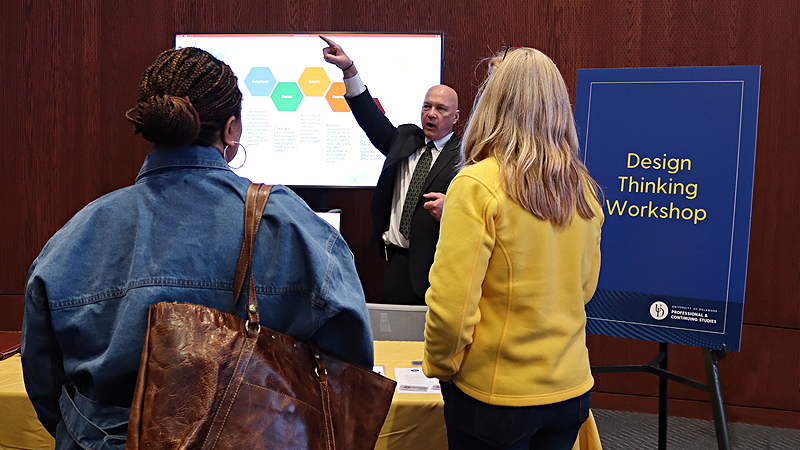 Edward Kashmere points while speaking with prospective students about Design Thinking Workshop