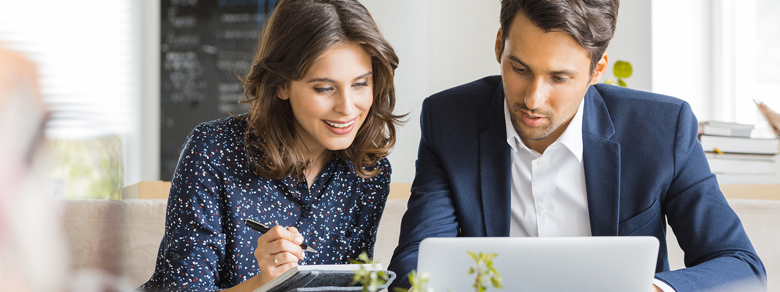 Woman and man looking at laptop screen