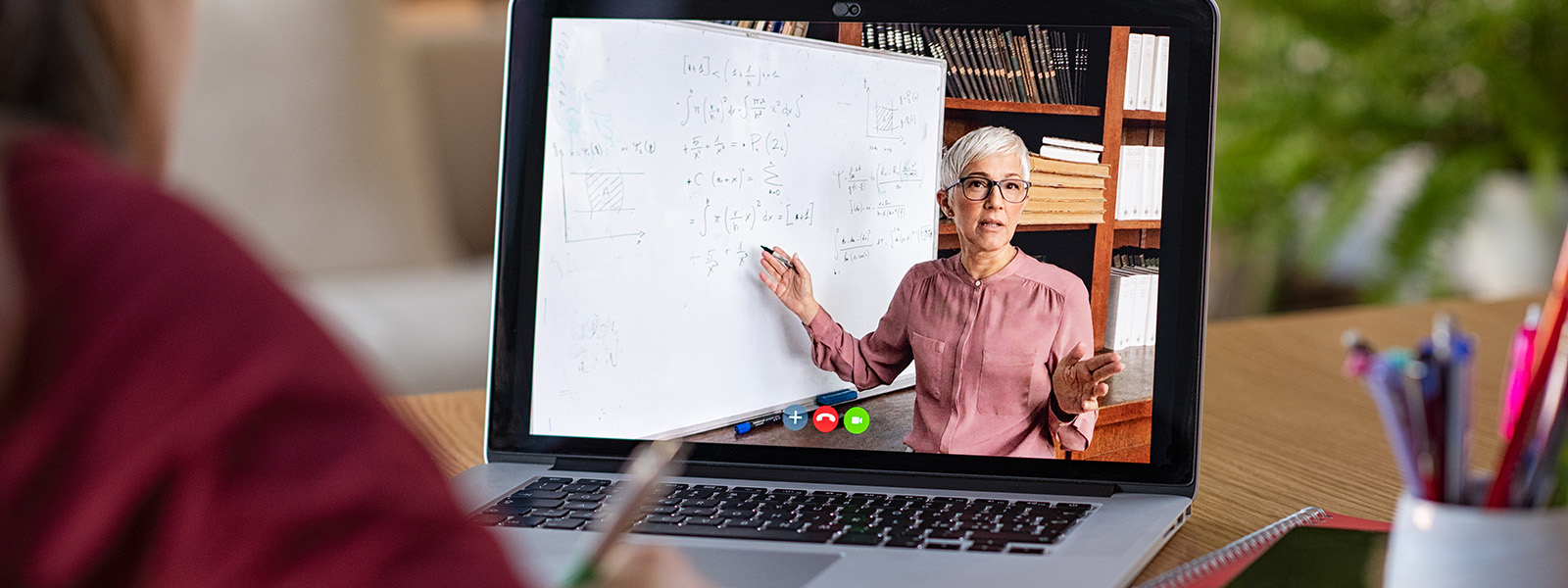 Female instructor presenting online lesson on laptop