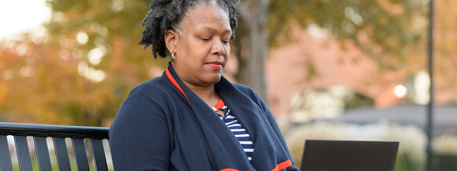 Student Thonnia Lee working on laptop outside