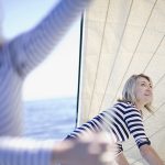 two-women-adjusting-boat-sails