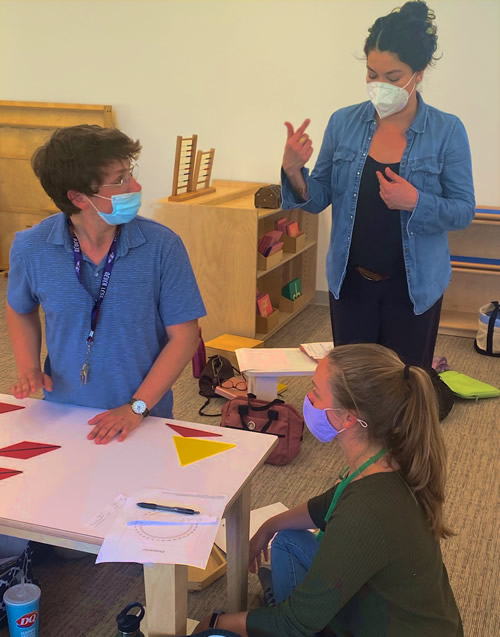 Teachers conferring in a classroom