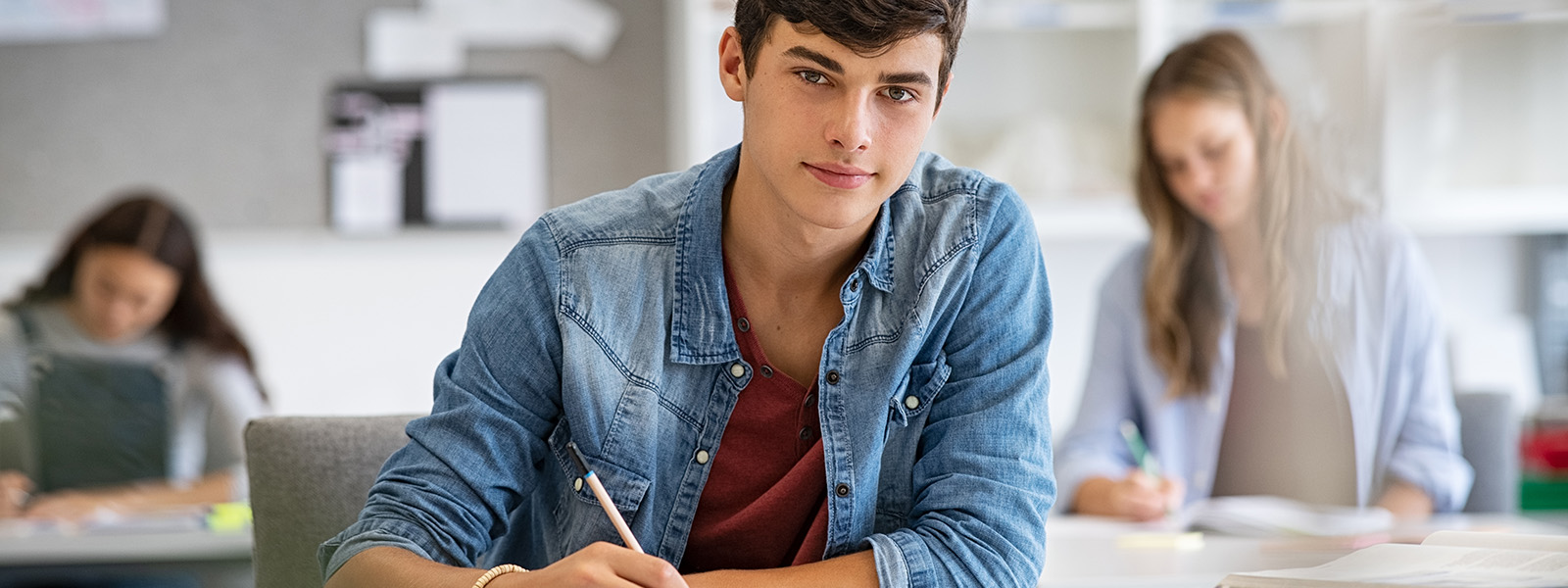 Male high school student in class looking forward
