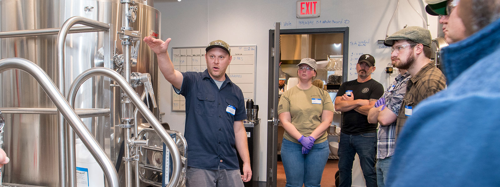 Brad Adelson speaking to students in brewery