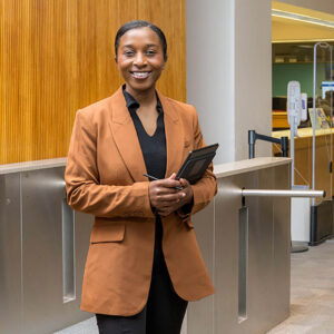 Joy Dufitumukiza standing in front of UD Morris Library turnstiles.