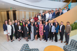 Incyte employees who recently finished their PocketMBA course pose on the steps of the company's Wilmington headquarters