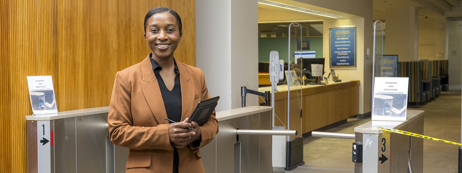 Joy Dufitumukiza in front of library turnstiles
