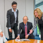 UD professors Rita Landgraf (standing, right) and Tom Tao (seated, right) engage with Incyte PocketMBA participants during a strategic planning session.