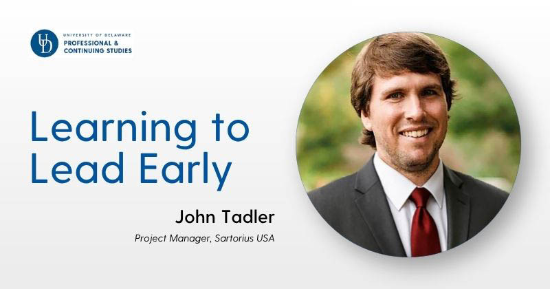 Header image featuring the University of Delaware Professional & Continuing Studies logo at top left, a large blue headline reading “Learning to Lead Early,” and below it the name “John Tadler” with the subtitle “Project Manager, Sartorius USA.” On the right side, a circular portrait shows a person in a suit and tie against a softly blurred green outdoor background.